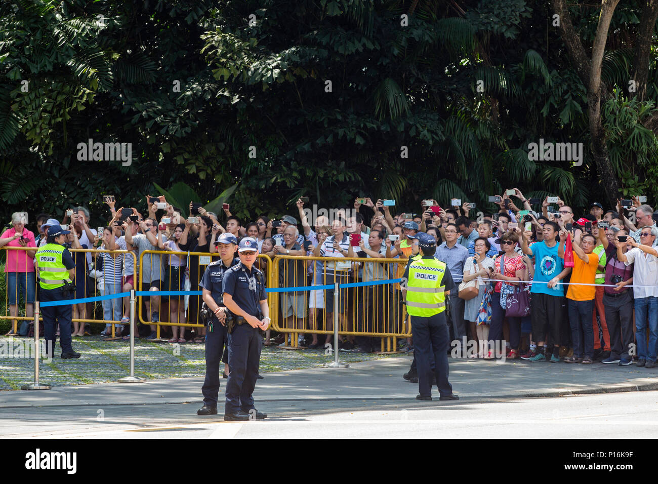 People gathered in front of the Istana are watching as the motorcade of US President Donald Trump enters the gate. Singapore Prime Minister Lee Hsien Loong and US President Donald Trump have a private meeting and a lunch ahead of the DPRK-US summit which is scheduled for June 12th. Stock Photo