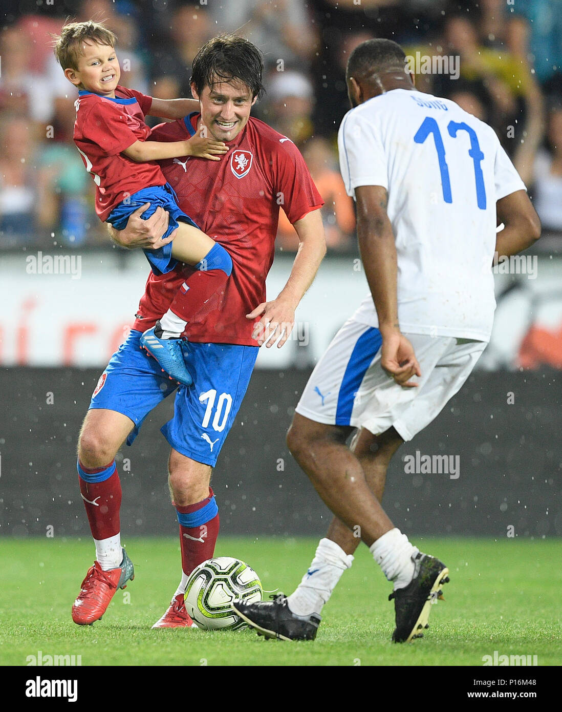 Tomas Rosicky and his son Tomas Rosicky Jr of Czech team and Alex Song of TR10 World Team in action during the match. Former captain of the Czech national football team Tomas Rosicky definitely ended his career at the age of 37 in a farewell match played despite a driving cloudburst which postponed its kickoff today, on Saturday, June 9, 2018. The Czech team, in which he played, defeated the 'team of the world,' composed of his former fellow players from Borussia Dortmund and Arsenal London, 5-2. The final goal was scored by Rosicky's four-year-old son Tomas. Weather complicated the farewell m Stock Photo