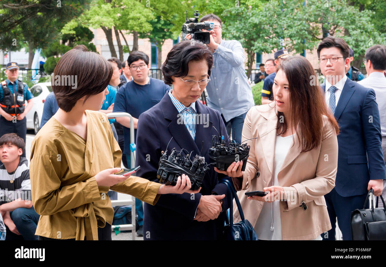 Lee Myung-Hee, June 11, 2018 : Reporters ask questions as Lee Myung-Hee (C, 69), wife of Korean Air Lines Co. chief Cho Yang-Ho, appears for questioning at the Seoul office of the Korea Immigration Service in Seoul, South Korea. She is accused of hiring about two dozen maids from the Philippines for at least the past decade by sponsoring them with traineeship visas in violation of the law. The authorities suspect she had the airline's human resources department and its Manila branch recruit the housekeepers. She was questioned by police two times in May over various assault charges but she avo Stock Photo
