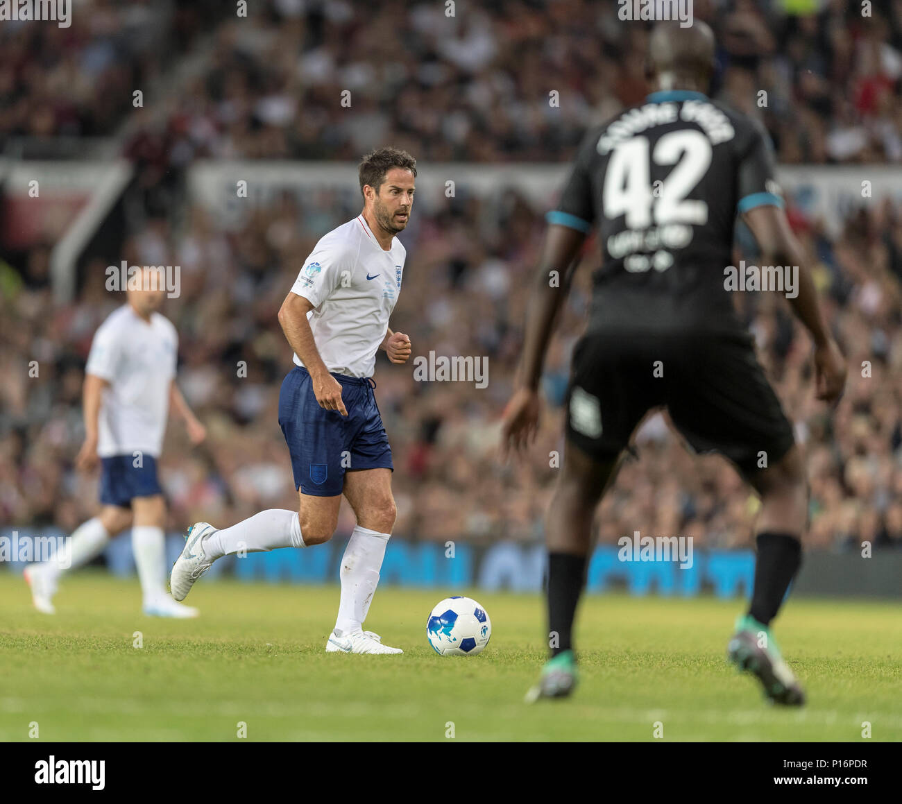 Manchester, England.10th June,2018. Jamie Redknapp is faced by Yaya Toure during the Soccer Aid charity football match between an England X1 and a World X1. Each team of A-list celebrities and Sporting legends are fundraising for UNICEF. © Andy Gutteridge/ Image and Events/ Alamy Live News Stock Photo