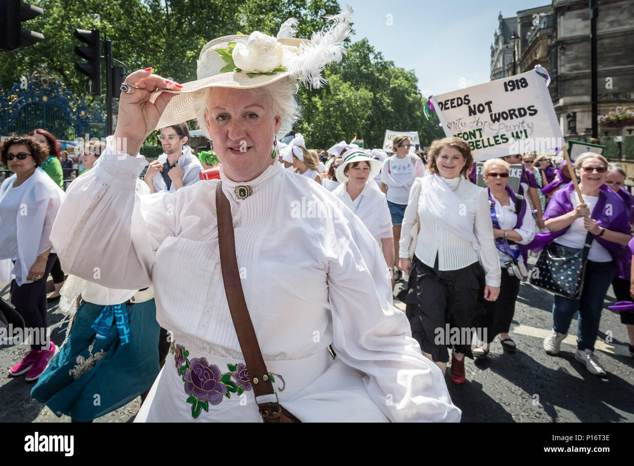 London, UK. 10th June 2018. Thousands of women join Processions 2018. Dressing in the green, white and purple tri-colour scheme of the Suffragette’s Women's Social and Political Union, they marched from Hyde Park to Parliament Square to mark 100 years since the Representation of the People Act, which gave British women the right to vote and stand for public office in the UK. Credit: Guy Corbishley/Alamy Live News Stock Photo