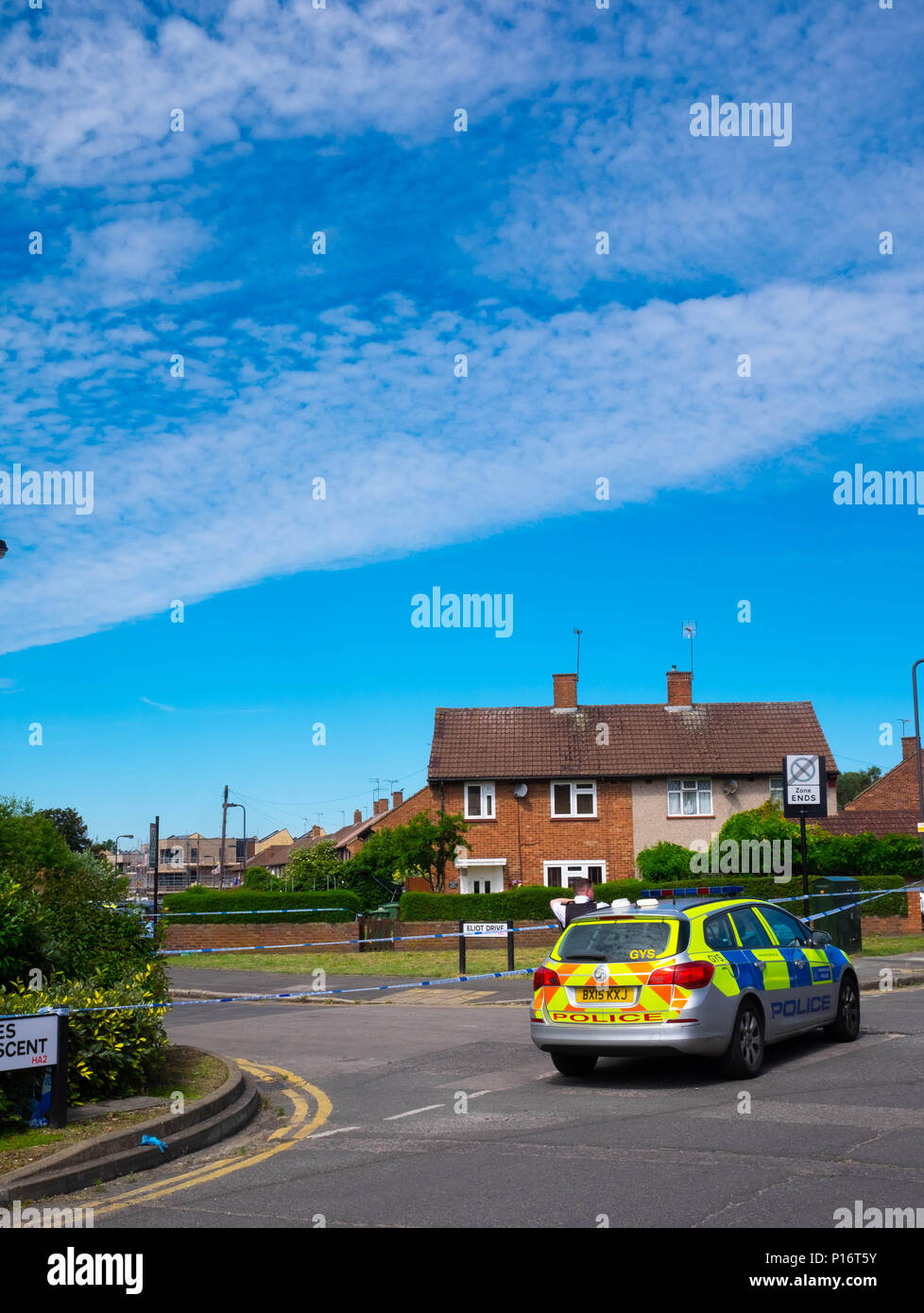 London, England. 11th June 2018. The morning after another teenager is stabbed in London, a forensic officer checks the crime scene for clues within an area cordoned off by the Police. This stabbing happened just a short time after a man was stabbed a few miles away in Northolt. ©Tim Ring/Alamy Live News Stock Photo