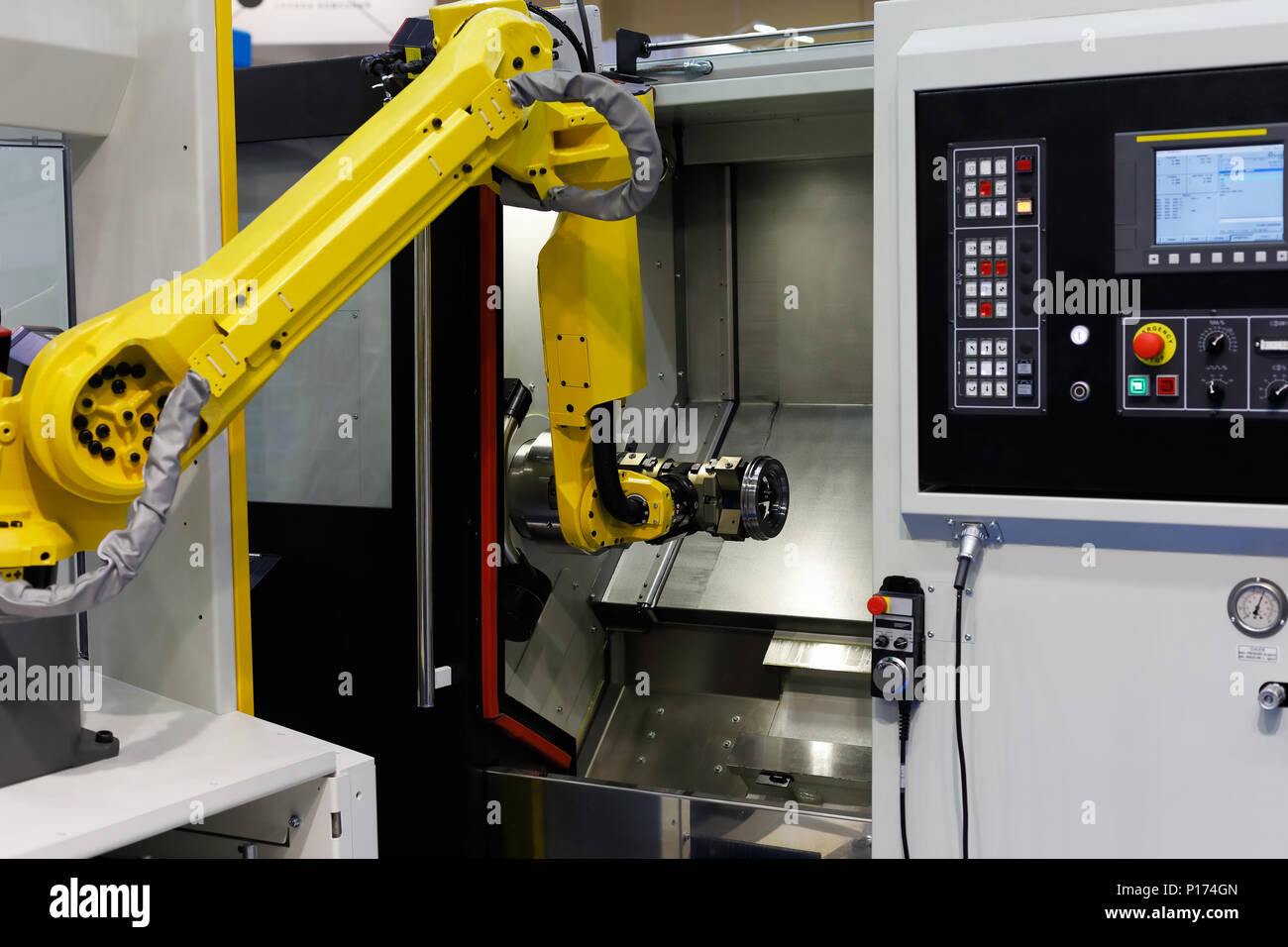 CNC lathe machine and robot used for automation of loading and unloading  operations. Selective focus Stock Photo - Alamy