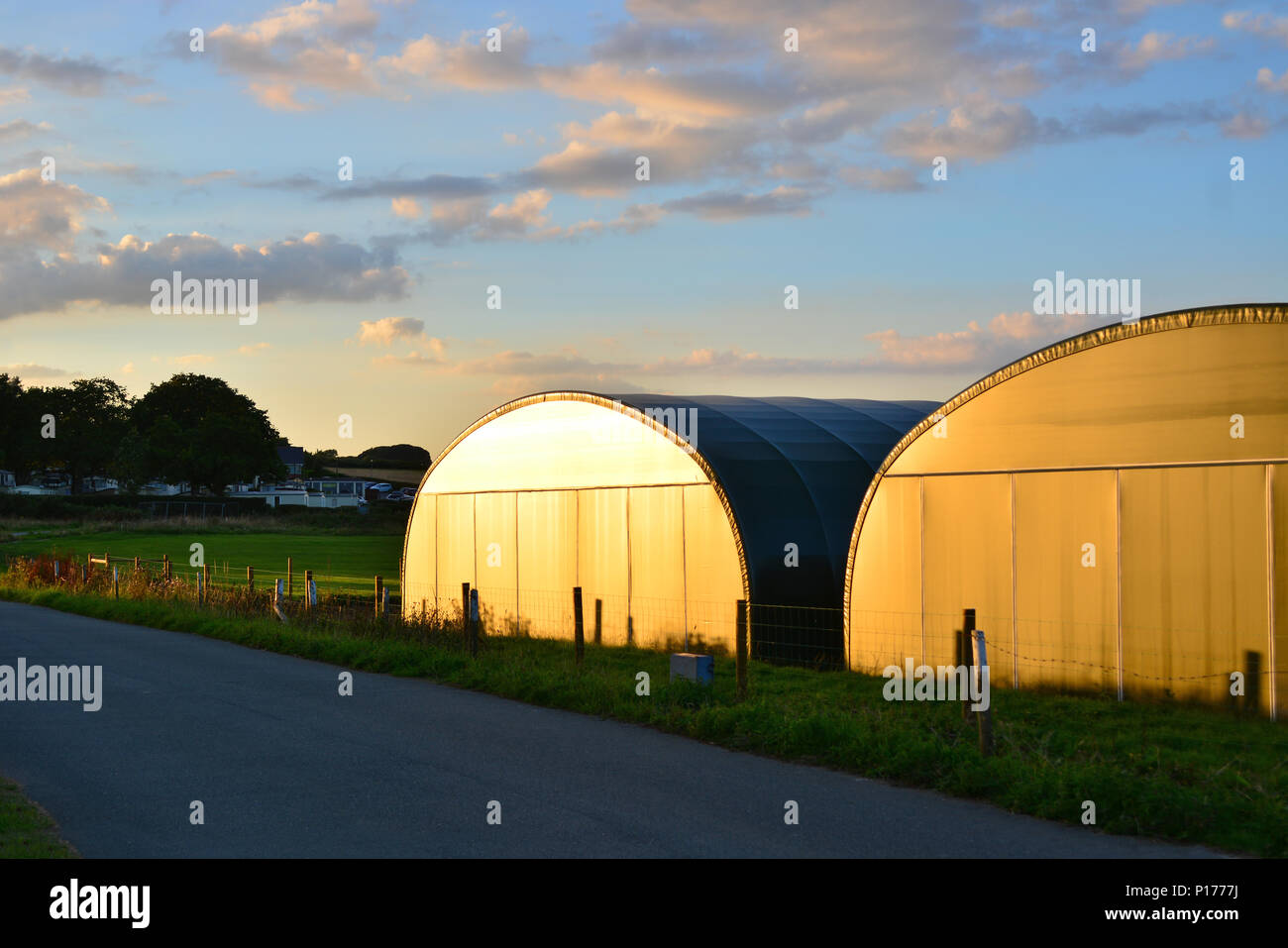 Temporary aircraft hangers reflecting sunlight at Sandown Airport on the Isle of Wight. Stock Photo