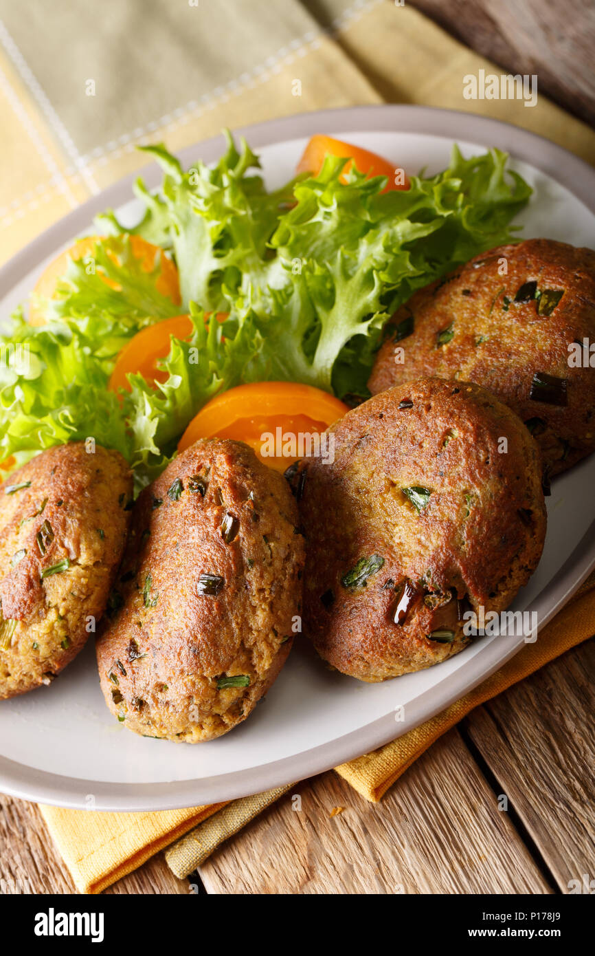 Tuna Patties with potatoes and spices h fresh salad closeup on a plate on the table. vertical Stock Photo