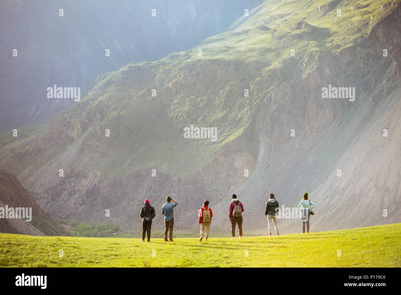 Group of people against mountains valley Stock Photo