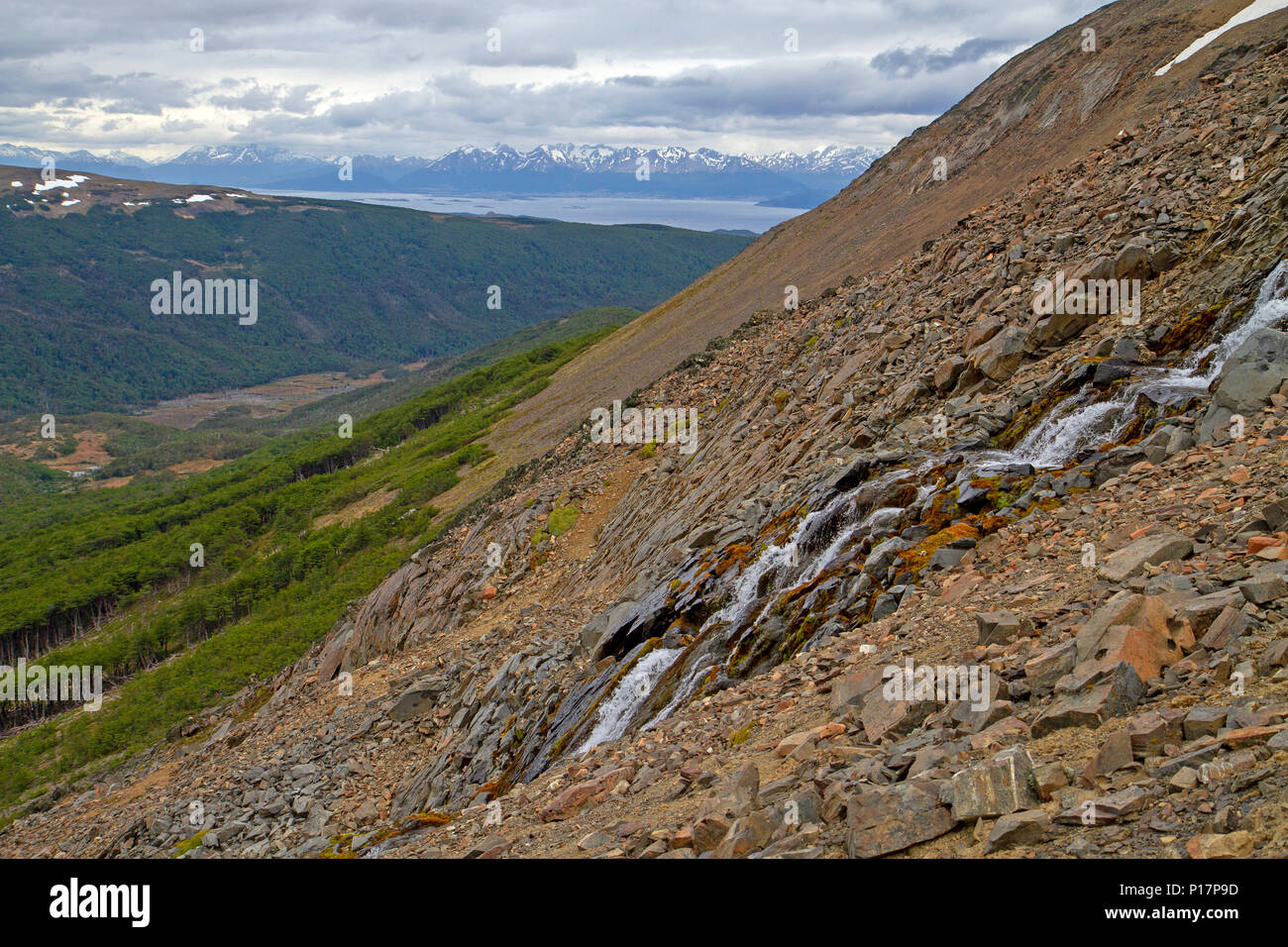 Waterfall pouring down from Paso Virginia along the Dientes Circuit Stock Photo