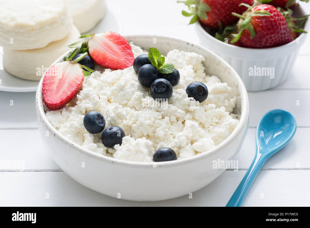 Curd cheese, farmer cheese, tvorog or quark fresh berries in a bowl