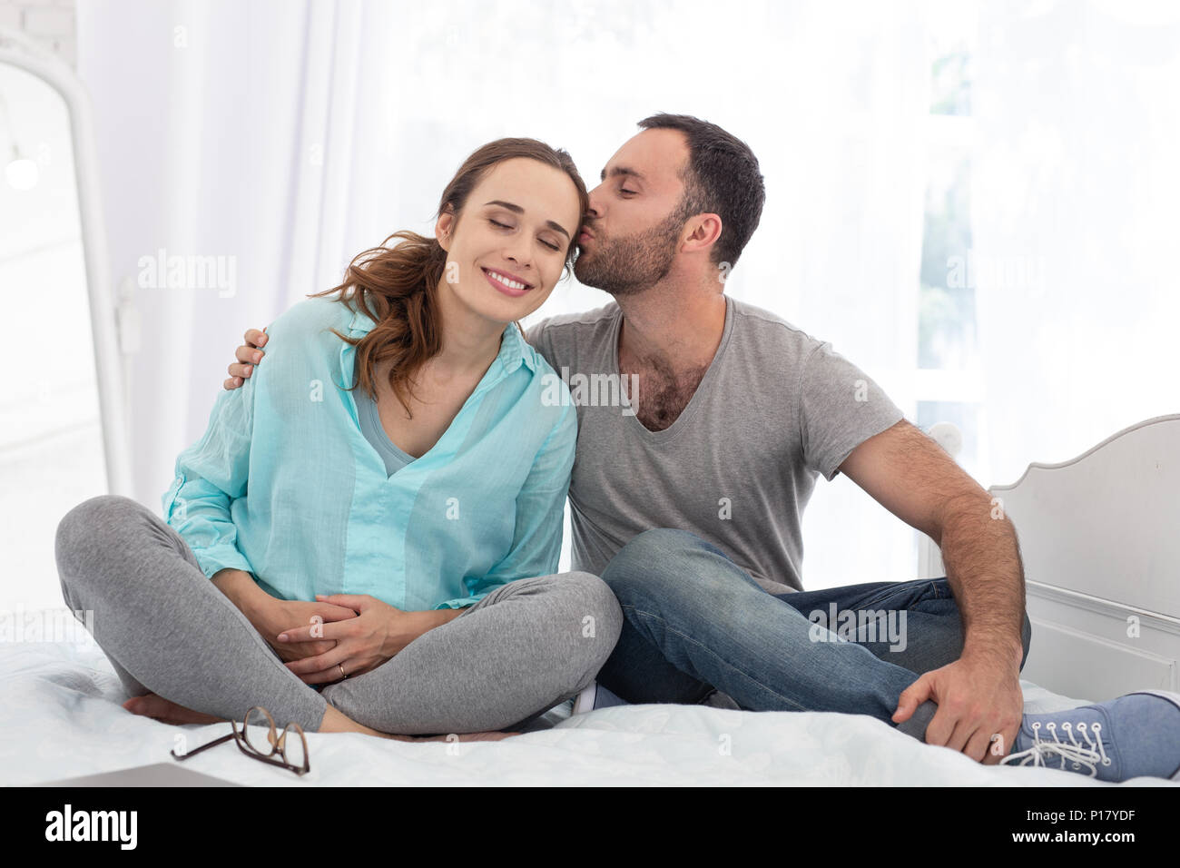 Adorable man adoring pregnant woman Stock Photo