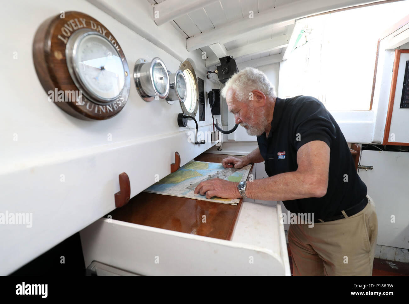 Sir Robin KnoxJohnston studies charts on board Suhaili on which he