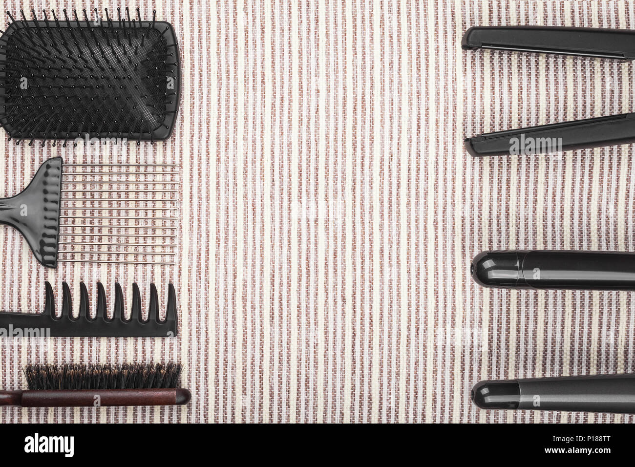 hair straightening tools lying opposite to brushes Stock Photo