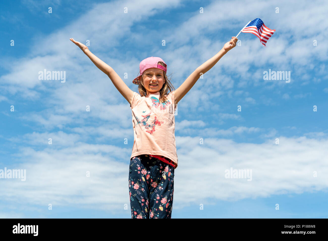 Little girl holding an american flag Stock Photo - Alamy