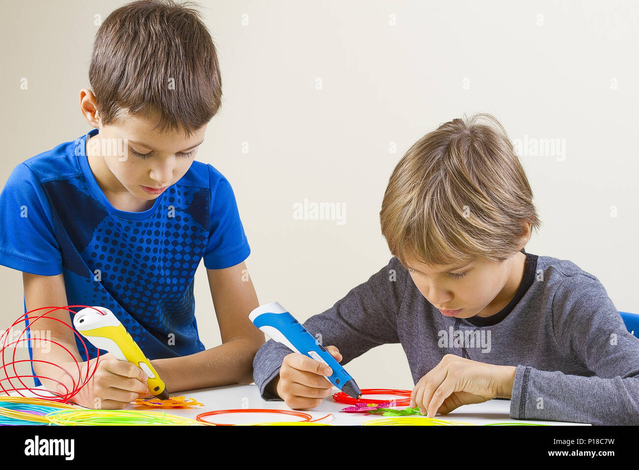 Happy children creating with 3d printing pen Stock Photo - Alamy