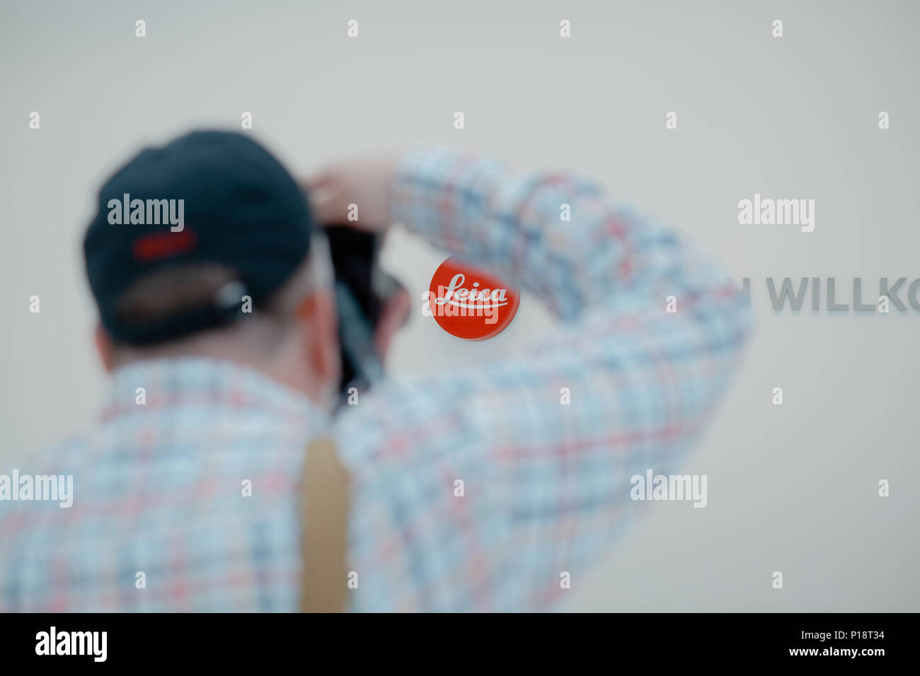 WETZLAR, MAY 2018 - A photographer takes photo of Leica logo and Welcome sign at Leica Camera AG headquarters complex at the Leitz Park in Wetzlar Stock Photo