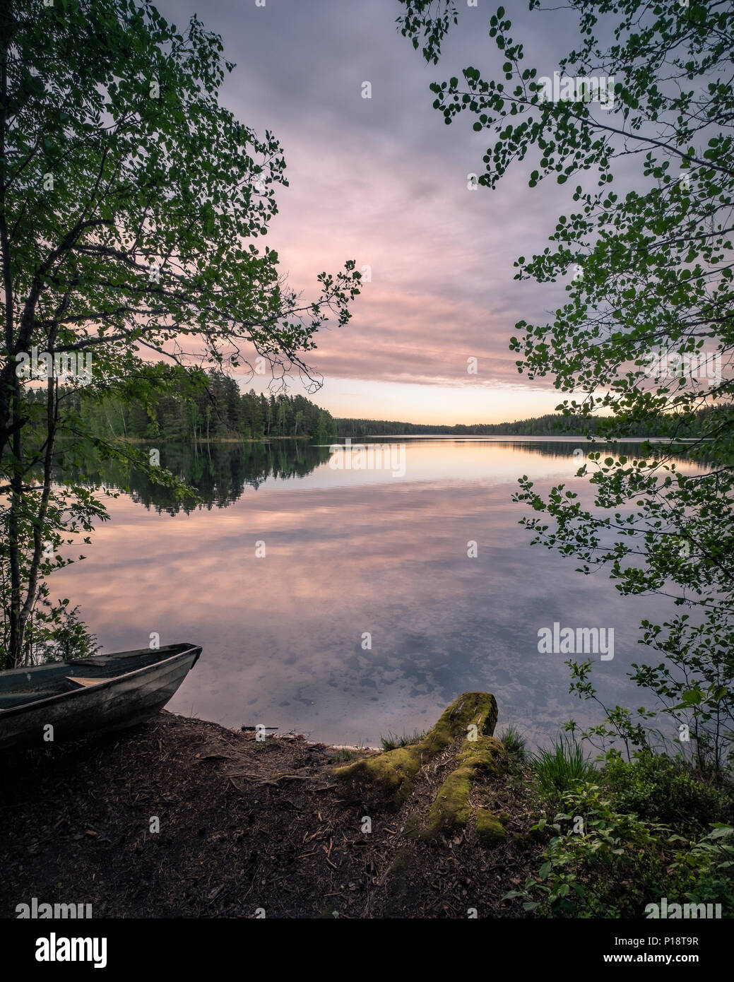 Scenic landscape with idyllic lake view and boat at summer evening in Finland Stock Photo