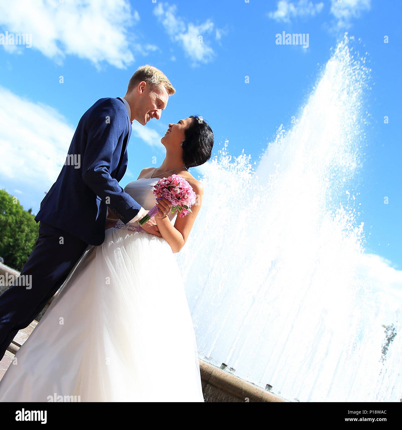 happy bride and groom on the background of the city Stock Photo - Alamy