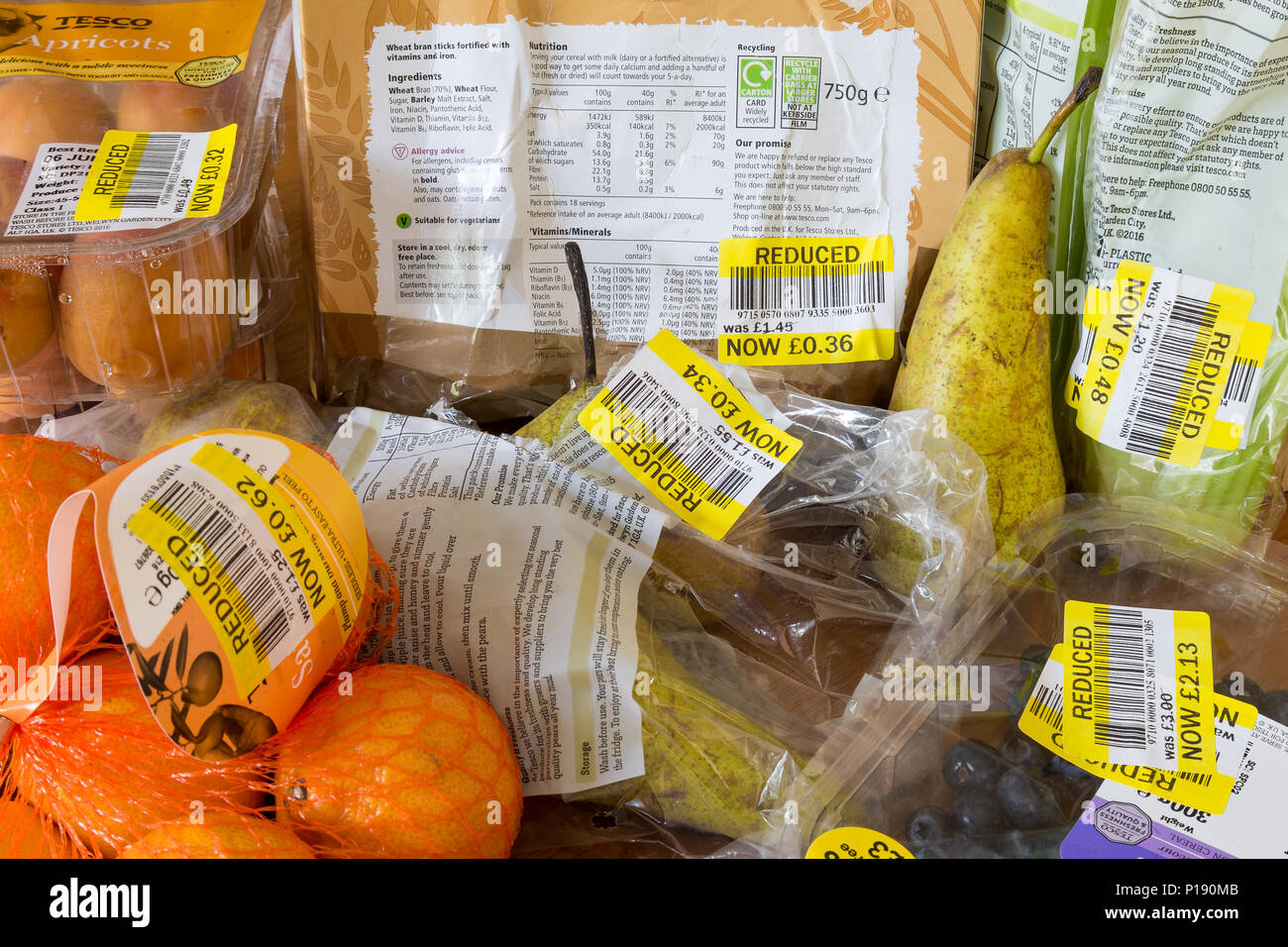 Thrifty shopping. Saving money. Close up of food products with yellow, reduced stickers. Fresh fruit past sell-by date. Out of date food. Poverty UK. Stock Photo