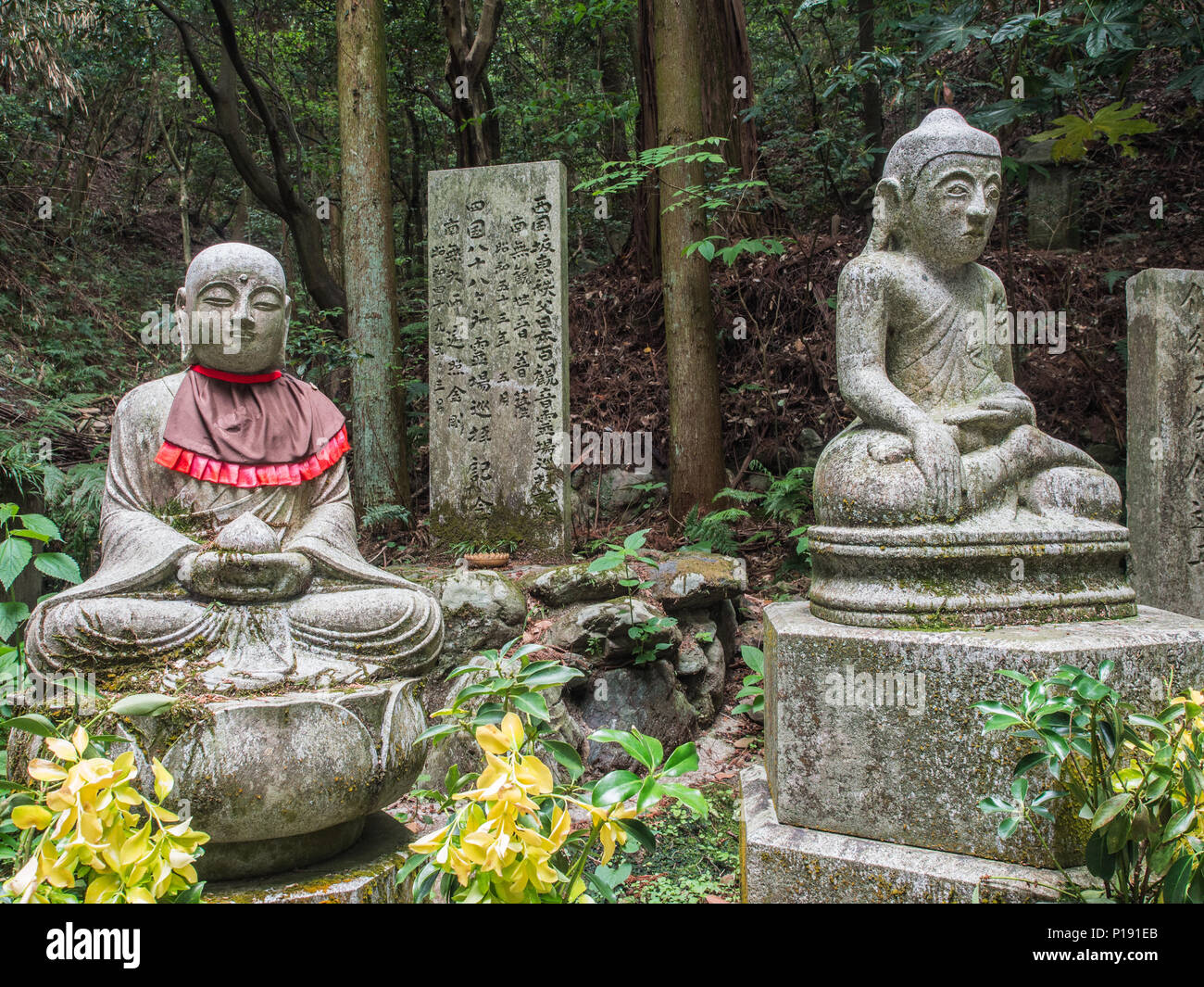 Buddhist deities, statues with stone monument, Taisanji temple 52,  Shikoku 88 Temple  pilgrimage,   Ehime, Japan. Stock Photo