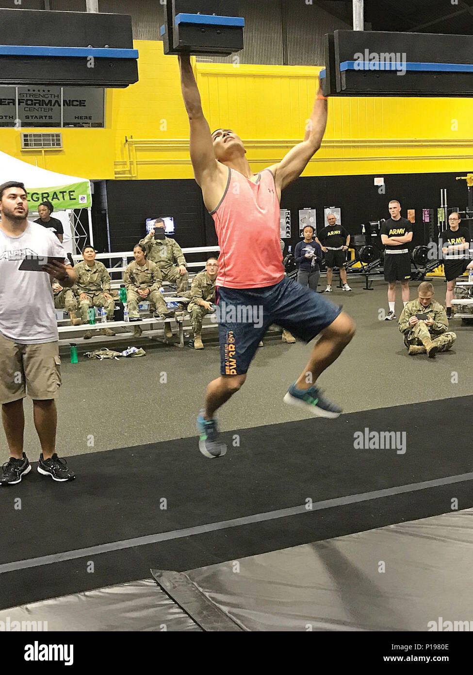 Staff Sgt. Jimmy Lim, Echo Company, 832nd Ordnance Battalion, swings his way across the cliff hanger obstacle on the Alpha Warrior Battle Rig set up at the Fort Lee Strength Performance Center Sept. 30. Stock Photo