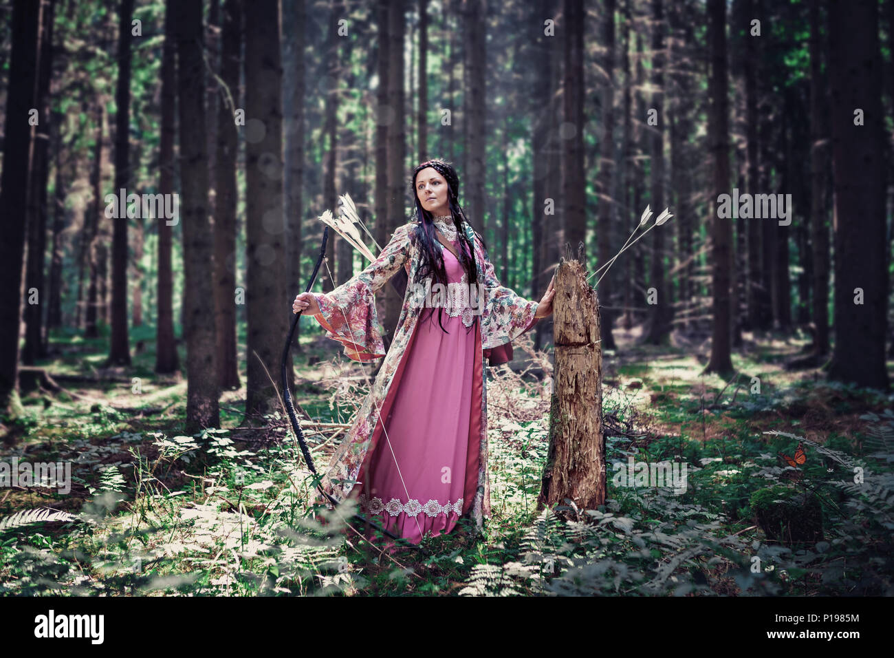 an outdoor portrait of a female elf with bow in a magic forest Stock ...