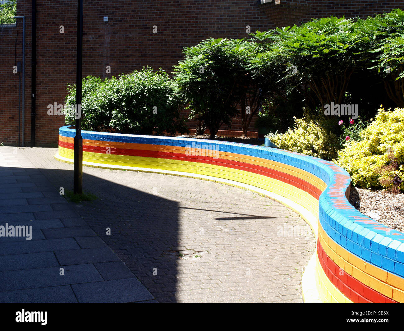 Brightly coloured painted brick wall in Bitterne Village Shopping
