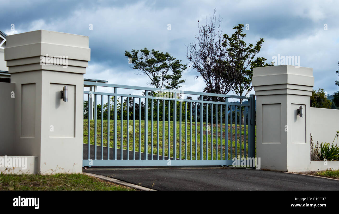 Metal driveway private residence property entrance gates set in brick