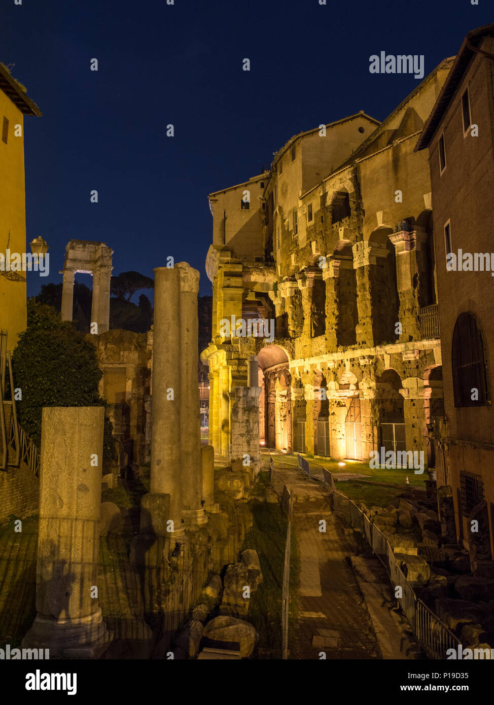 Rome, Italy - March 25, 2018: The ruins of the Roman Temple of Apollo Sosianus and the Theatre of Marcellus are lit up at night. Stock Photo