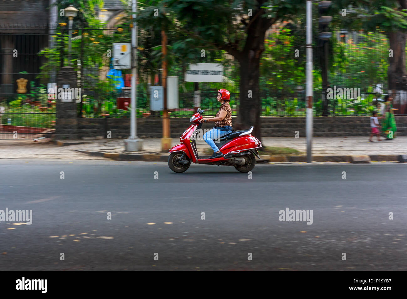 MUMBAI, INDIA - DECEMBER 4, 2016 : A women riding a motor bike on streets of Mumbai Stock Photo
