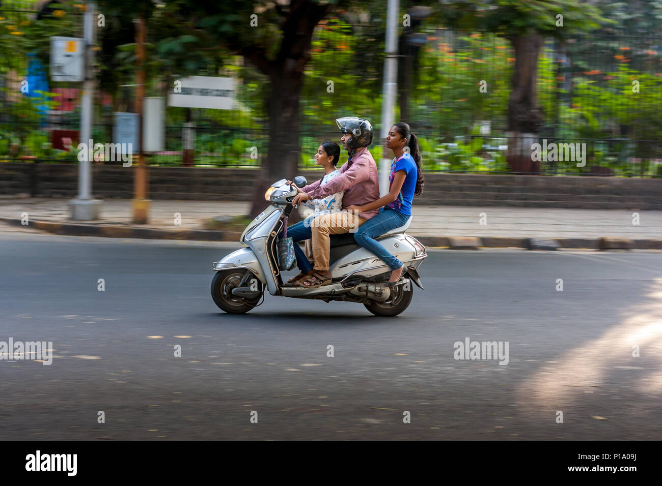 MUMBAI, INDIA - DECEMBER 4, 2016 : A family riding a motor bike on streets of Mumbai Stock Photo