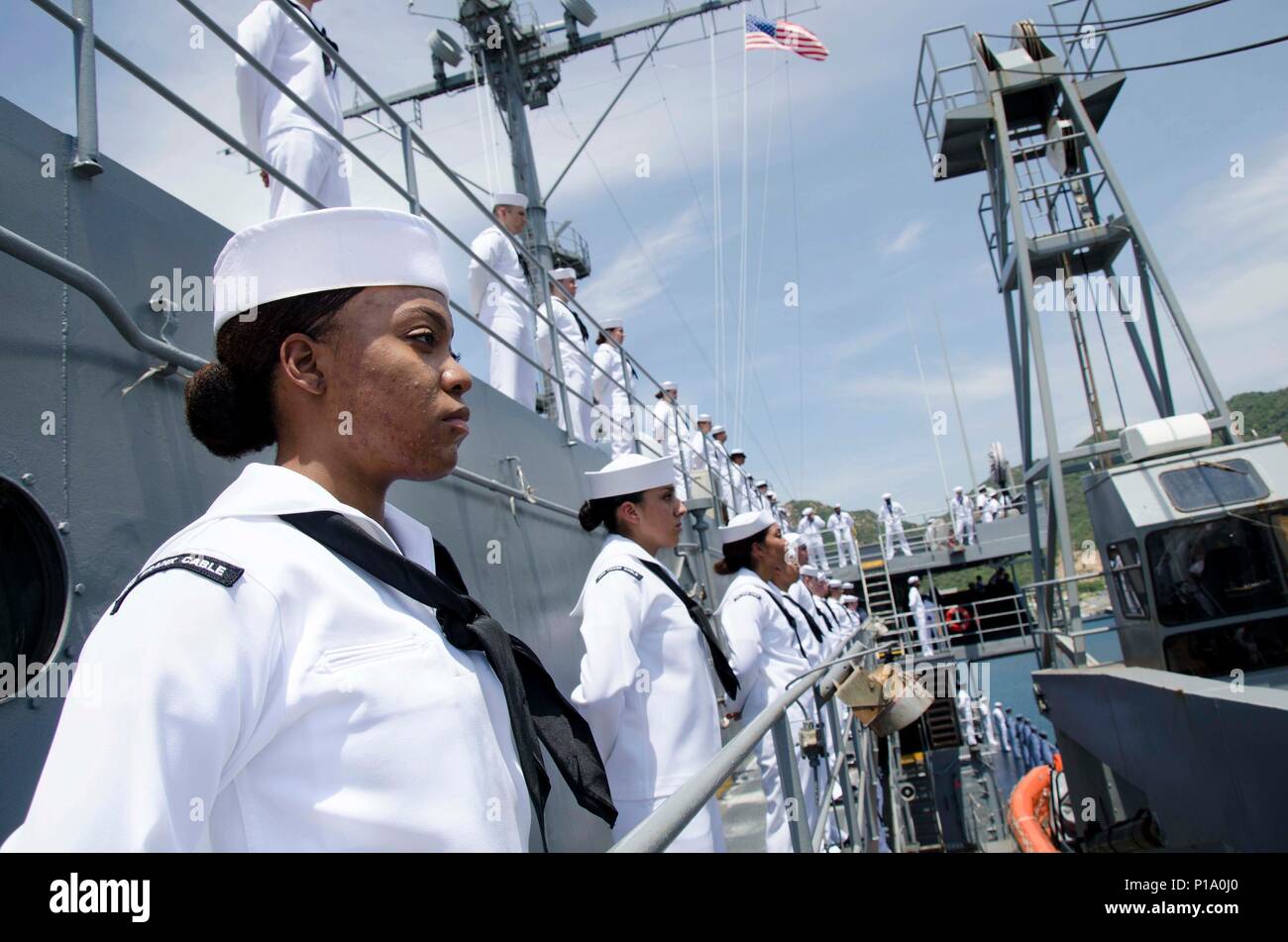 CAM RANH BAY, Vietnam (Oct. 2, 2016)  Petty Officer 3rd Class Michiah D. Naylor, a native of Louisville, Ky., assigned to the submarine tender USS Frank Cable (AS 40), mans the starboard-side rails with her shipmates, while pulling into Cam Ranh Bay, Vietnam, during a Naval Engagement Activity with the people of Vietnam, Oct. 2. In it's seventh year, NEA Vietnam is designed to foster mutual understanding, build confidence in the maritime domain and strengthen relationships between the U.S. Navy and Vietnam People's Navy and the local community. Frank Cable is one of two forward-deployed submar Stock Photo