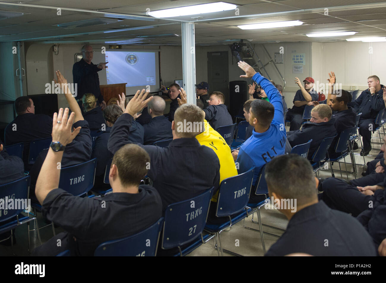 161003-N-XX566-008  PACIFIC OCEAN (Oct. 3, 2016) Sailors ask questions during a motorcycle mentorship session aboard USS John C. Stennis (CVN 74). The session allowed Sailors who were interested in riding motorcycles to learn more about motorcycles, safety, and equipment from experienced riders. John C. Stennis is underway conducting proficiency and sustainment training.  (U.S. Navy photo by Petty Officer 3rd Class Andre T. Richard/ Released) Stock Photo