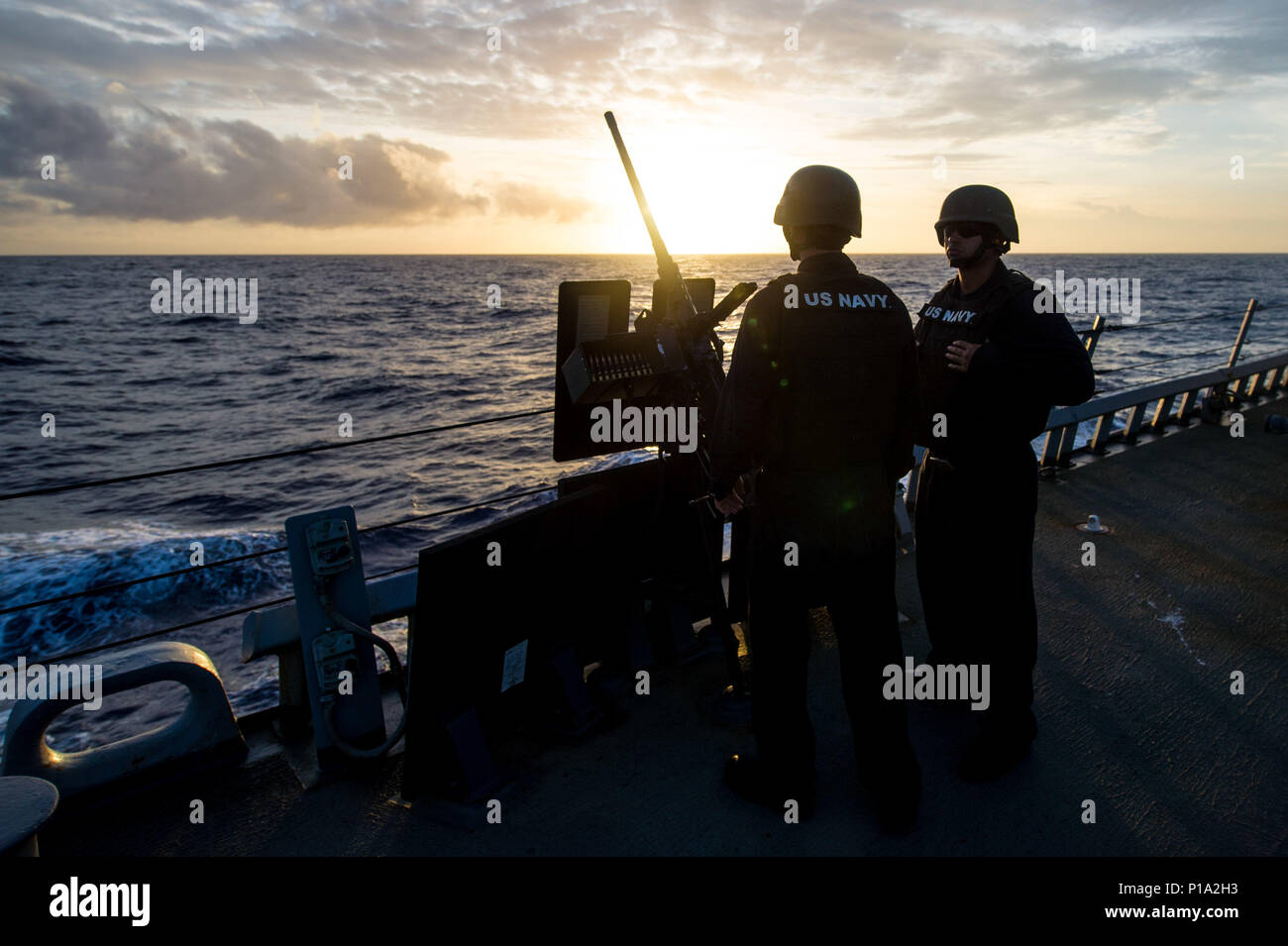 161002-N-UF697-004  PHILIPPINE SEA (Oct. 2, 2016) Seaman Zachary Murphree, from Quinlan, left, and Petty Officer 1st Class Jonathan Quevedo await green range clearance from the bridge during a live-fire .50 caliber machine gun qualification on the aft missile deck of the forward-deployed Arleigh Burke-class guided-missile destroyer USS Barry (DDG 52). Barry is on patrol with Carrier Strike Group Five (CSG 5) in the Philippine Sea supporting security and stability in the Indo-Asia-Pacific region. (U.S. Navy photo by Petty Officer 2nd Class Kevin V. Cunningham/Released) Stock Photo