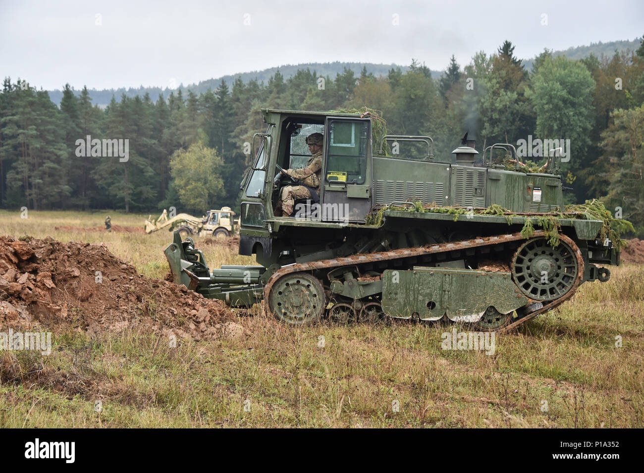 A U.S. Soldier, assigned to Bravo Troop, Regimental Engineer Squadron, 2d Cavalry Regiment, operates a M105 DEUCE-Deployable Universal Combat Earthmover during Exercise Allied Spirit V at 7th Army Training Command’s Hohenfels Training Area, Germany, Oct. 4, 2016. Exercise Allied Spirit includes about 2,520 participants from eight NATO nations, and exercises tactical interoperability and tests secure communications within Alliance members and partner nations.  (U.S. Army photo by Visual Information Specialist Gertrud Zach) Stock Photo