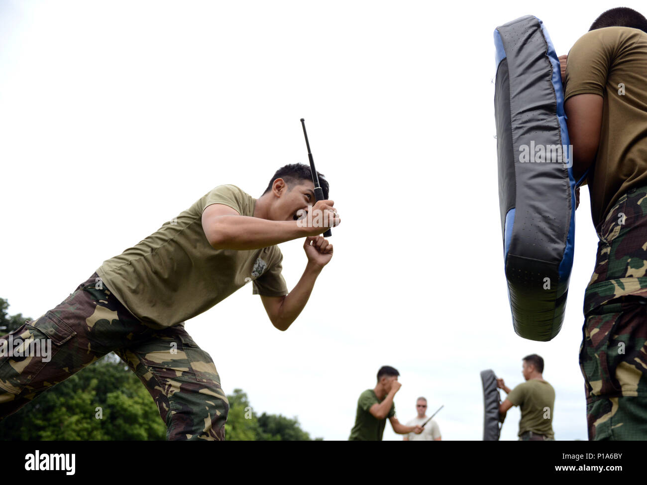 A Philippine Air Force Military Police Office Participates In Baton Practice A Nonlethal Means Of Subduing An Aggressor During A Subject Matter Expert Exchange With The United States As Part Of The A Philippine Air Force Military Police Office Participates In Baton Practice A Nonlethal Means Of Subduing An Aggressor During A Subject Matter Expert Exchange With The United States As Part Of The