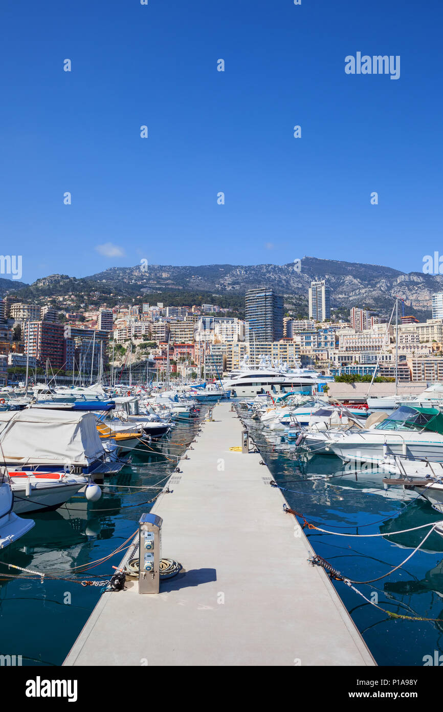Monaco principality cityscape, pier with boats and yachts at Port Hercule on Mediterranean Sea, view to Monte Carlo. Stock Photo