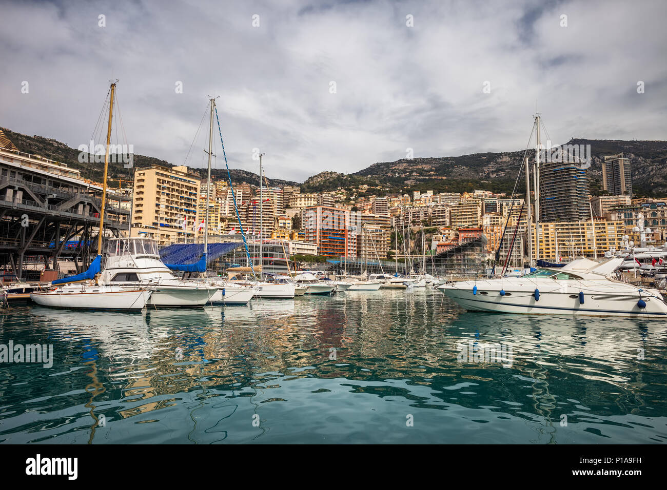 Monaco principality skyline as seen from Port Hercule, yachts and sailing boats on Mediterranean Sea, Europe. Stock Photo