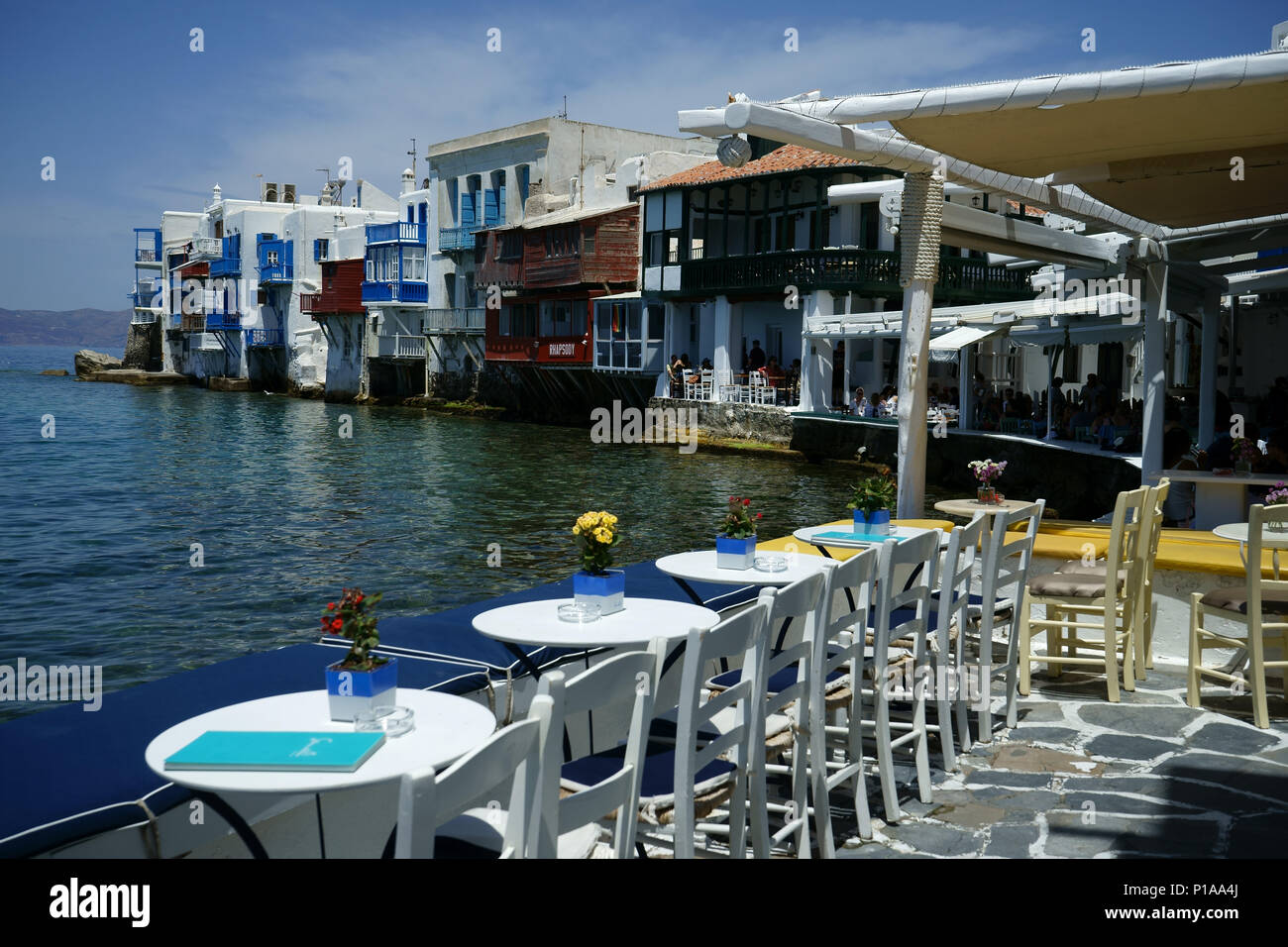 View from street restaurant along beach to area cald 'Llittle Venice' in town Mykonos, Cyclades islands, Greece Stock Photo