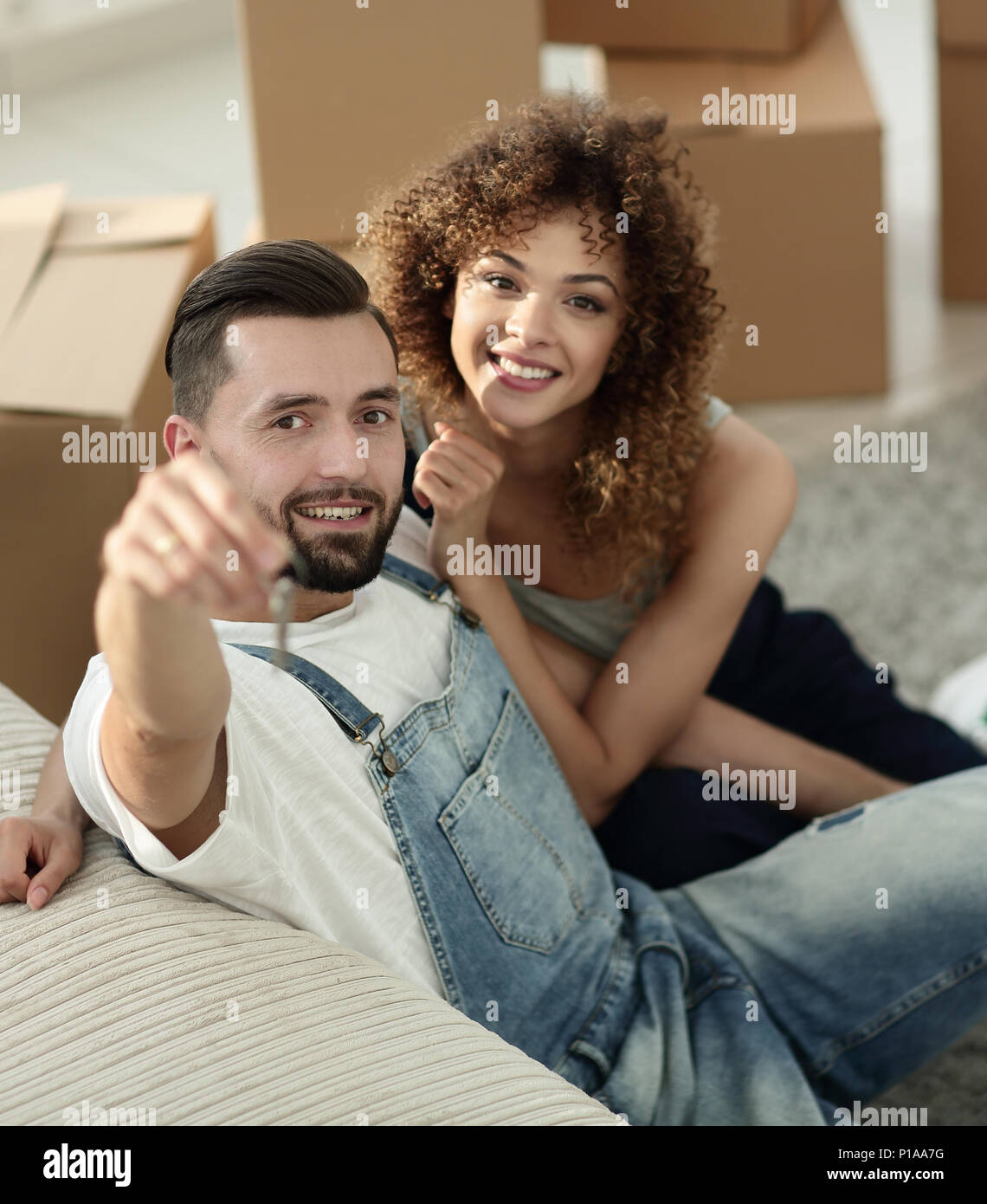 young couple holding the key to a new apartment Stock Photo - Alamy