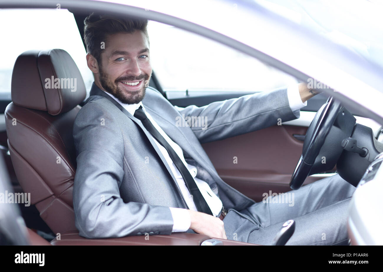 Handsome businessman in the drivers seat in his car Stock Photo - Alamy