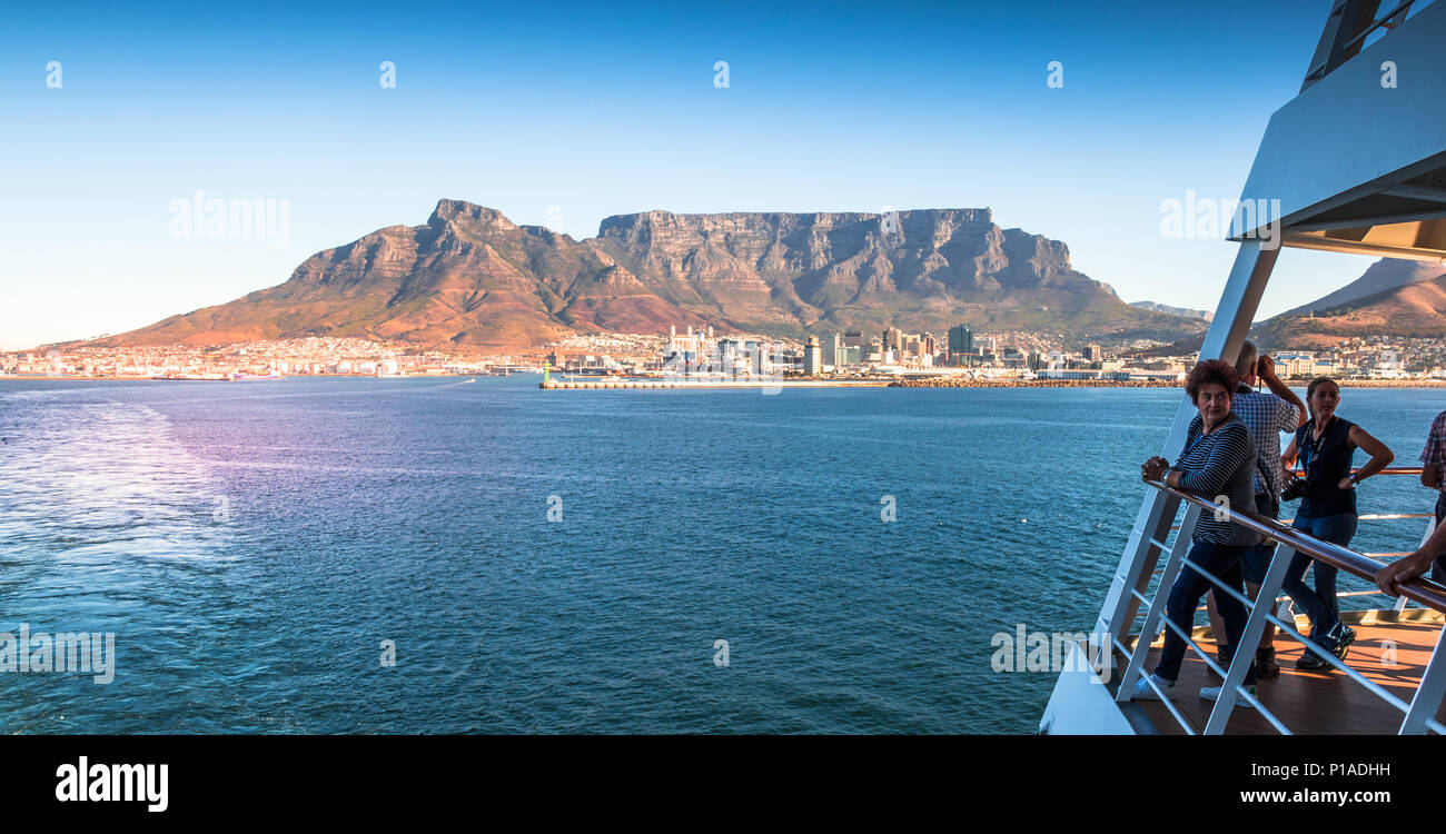 Cape Town, South Africa - unidentified passengers watch excitedly from deck as the liner leaves Table Bay Harbor image with copy space Stock Photo
