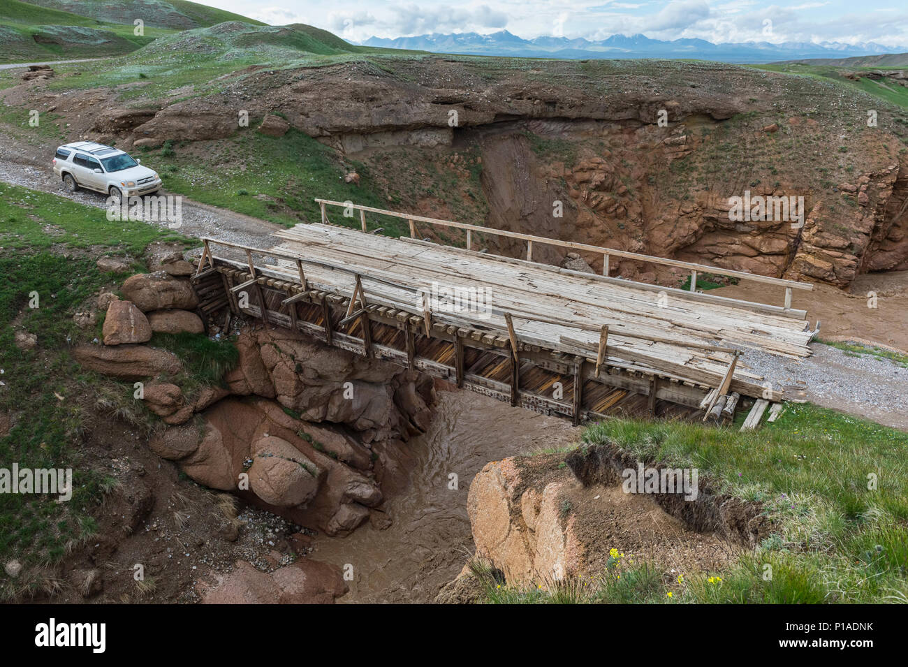 Wild George Drive Four wheel drive car crossing a wooden bridge over a wild gorge, Naryn ...