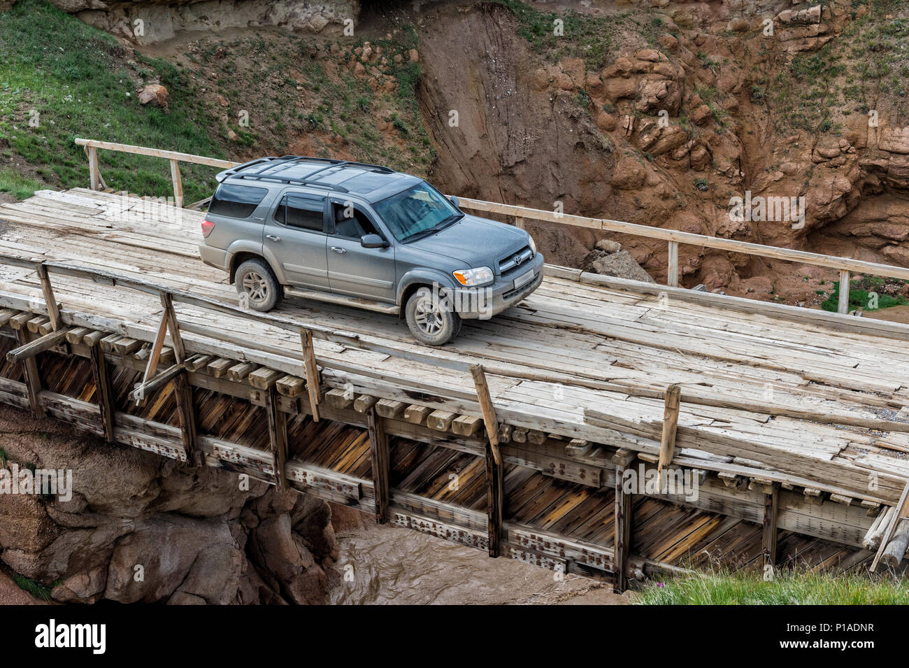 Four wheel drive car crossing a wooden bridge over a wild gorge, Naryn  Province, Kyrgyzstan Stock Photo - Alamy
