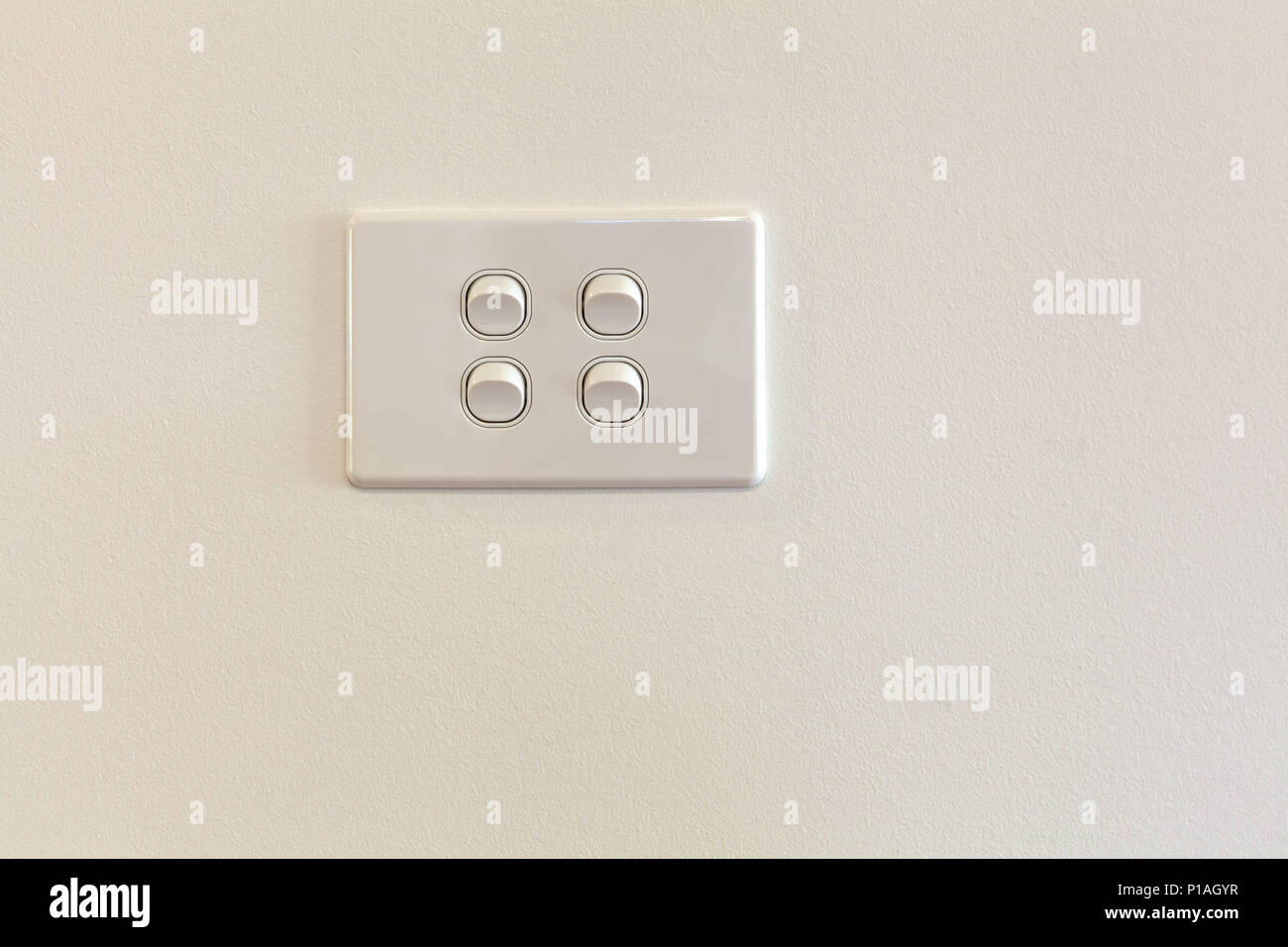 Quad modern light switch on white wall with copy space Stock Photo