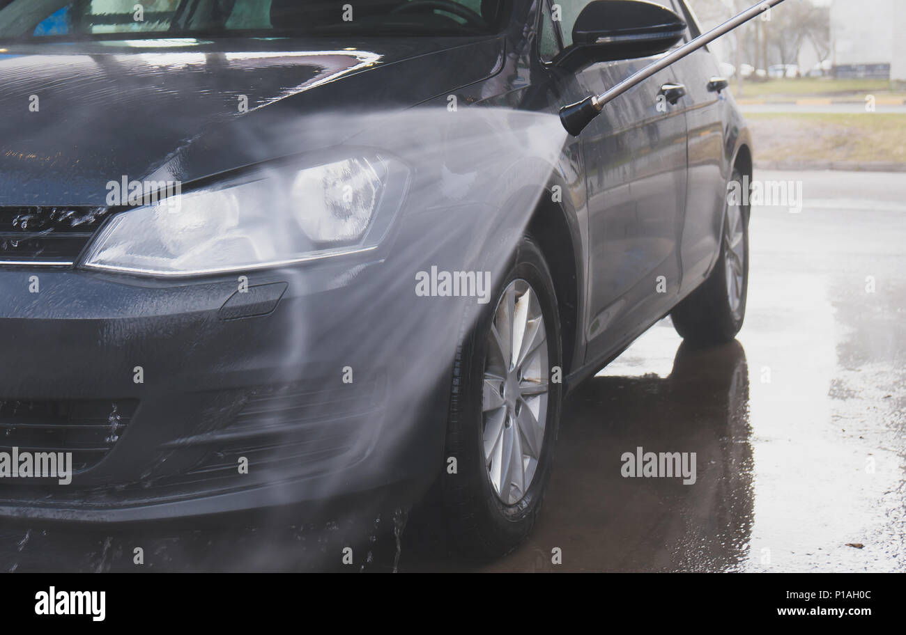 Car wash using high pressure water jet Stock Photo - Alamy