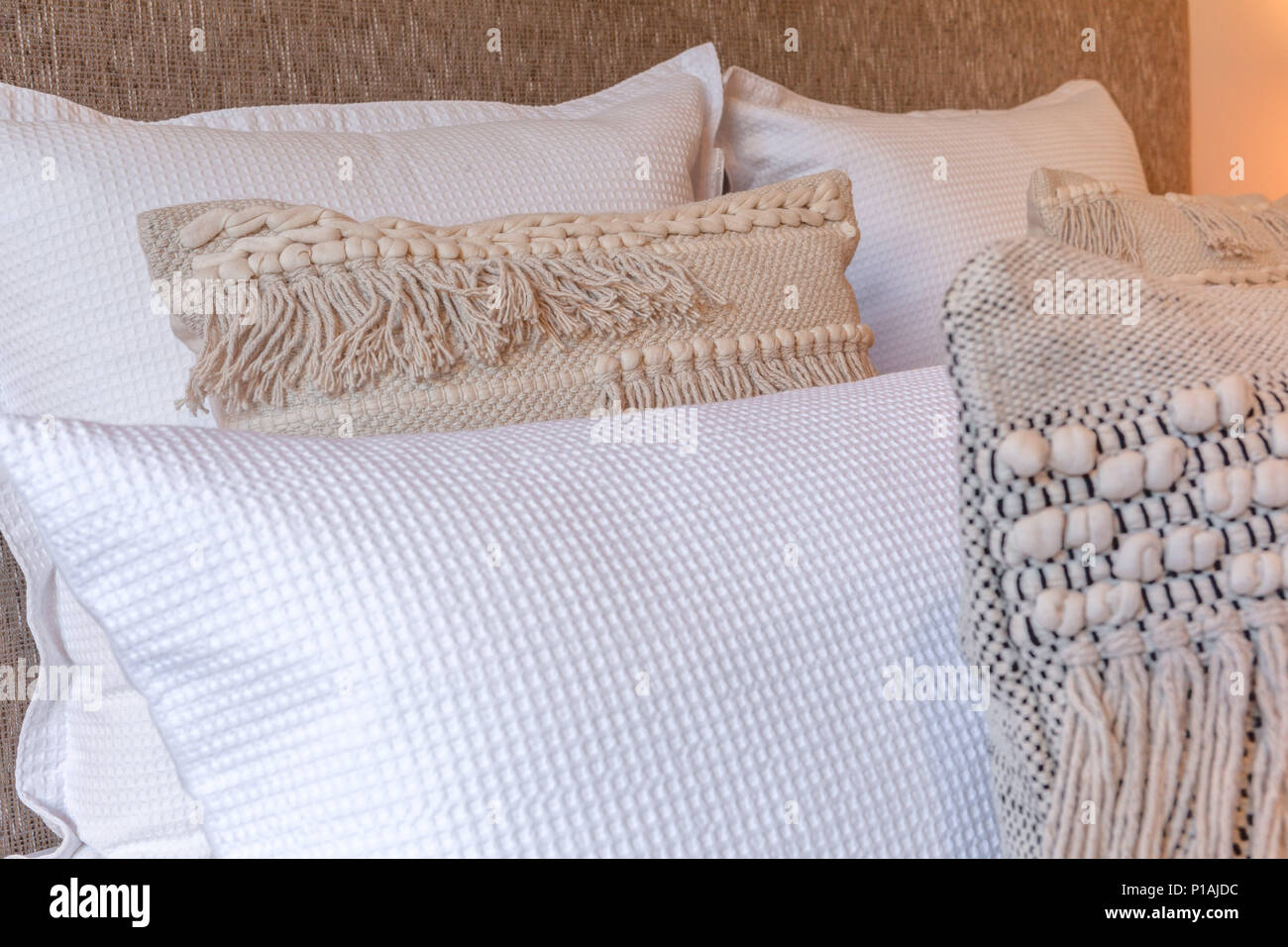 Decorative pillows on a bed in bedroom close-up Stock Photo
