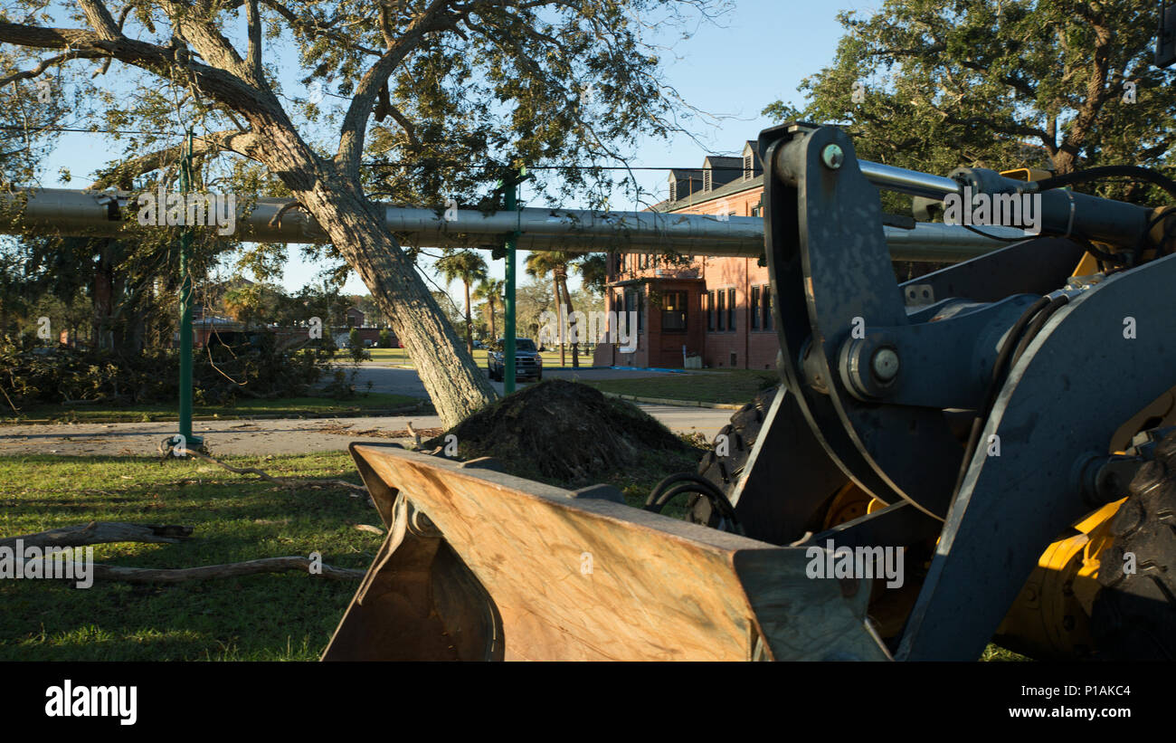 Marines from the Facilities Maintenance Division clear debris caused by Hurricane Matthew Oct. 9, 2016, on Parris Island, S.C. FMD provides technical direction, staff cognizance, emergency support and maintenance functions to recruit training facilities and the Eastern Recruiting Region. To ensure the safety of approximately 6,000 recruits in training, Recruit Training Regiment evacuated to Marine Corps Logistics Base Albany due to inclement weather from the hurricane. Recruit training will resume aboard Parris Island when conditions are met for safe travel back and when training can be proper Stock Photo