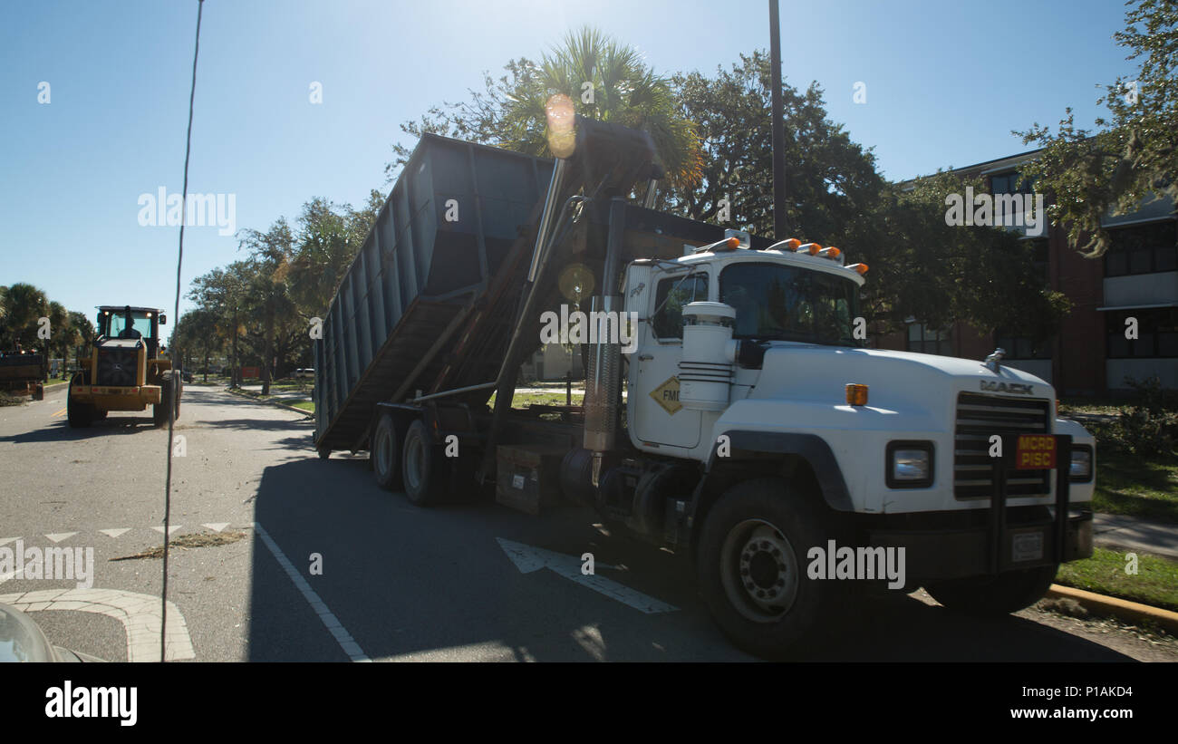 Marines from the Facilities Maintenance Division prepare to load debris caused by Hurricane Matthew Oct. 9, 2016, on Parris Island, S.C. FMD provides technical direction, staff cognizance, emergency support and maintenance functions to recruit training facilities and the Eastern Recruiting Region. To ensure the safety of approximately 6,000 recruits in training, Recruit Training Regiment evacuated to Marine Corps Logistics Base Albany due to inclement weather from the hurricane. Recruit training will resume aboard Parris Island when conditions are met for safe travel back and when training can Stock Photo