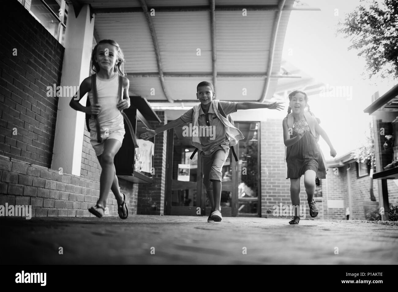 Kids running in school corridor Stock Photo