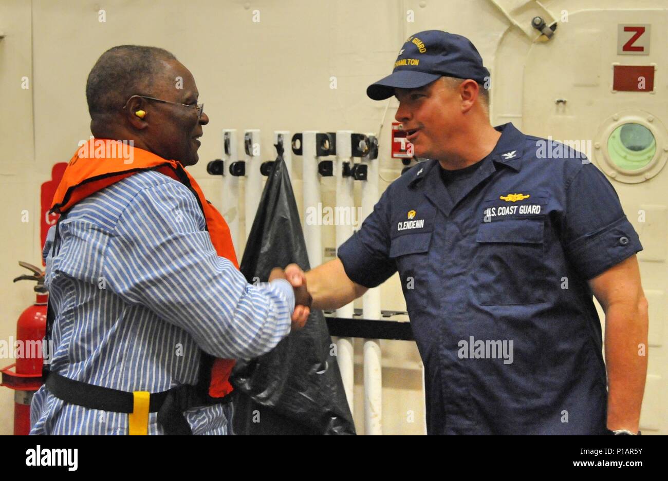 Coast Guard Capt. Scott Clendenin, commanding officer of the Coast Guard Cutter Hamilton, homeported in Charleston, South Carolina welcomes the President of Haiti, Jocelerme Privert, aboard the Hamilton off the coast of Jeremie, Haiti, Saturday, Oct. 8, 2016. The Hamilton crew transported disaster relief supplies to the country after it was affected by Hurricane Matthew. U.S. Coast Guard photo by Petty Officer 1st Class Joseph Cook. Stock Photo