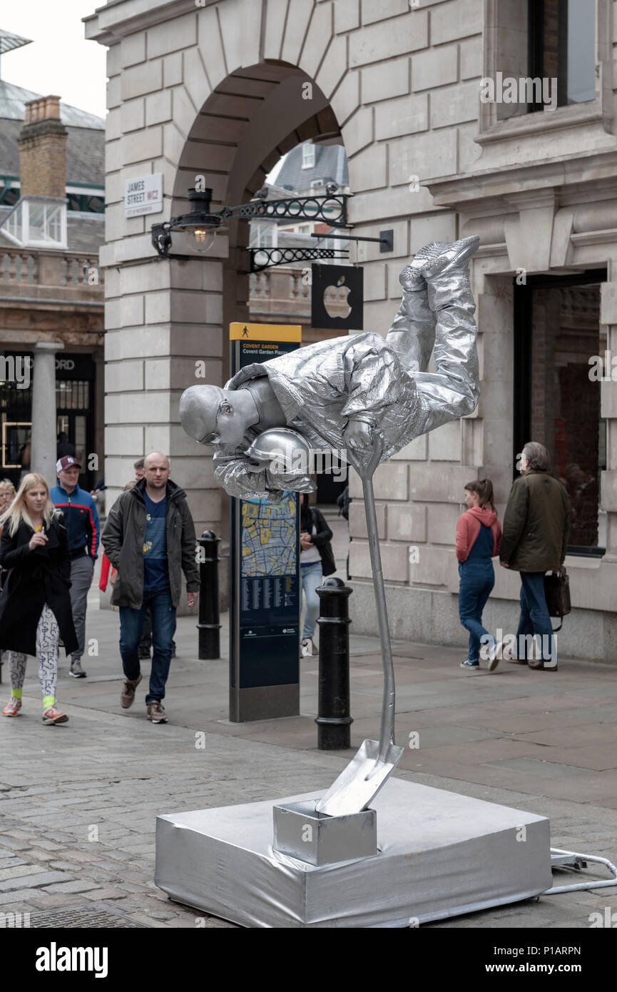 Silver painted street performer in hires stock photography and images